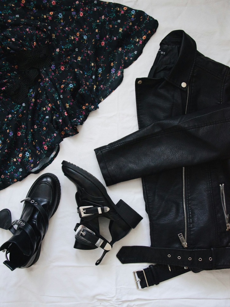 A belted black biker jacket styled flat with a floral dress — a close Vinted match